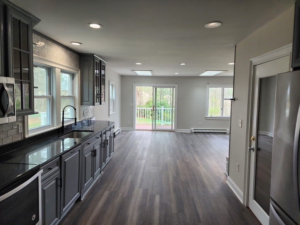 81 Onset Avenue Wareham, MA 02532 - Photo 20 of 42 a kitchen with stainless steel appliances granite countertop a stove and wooden floor