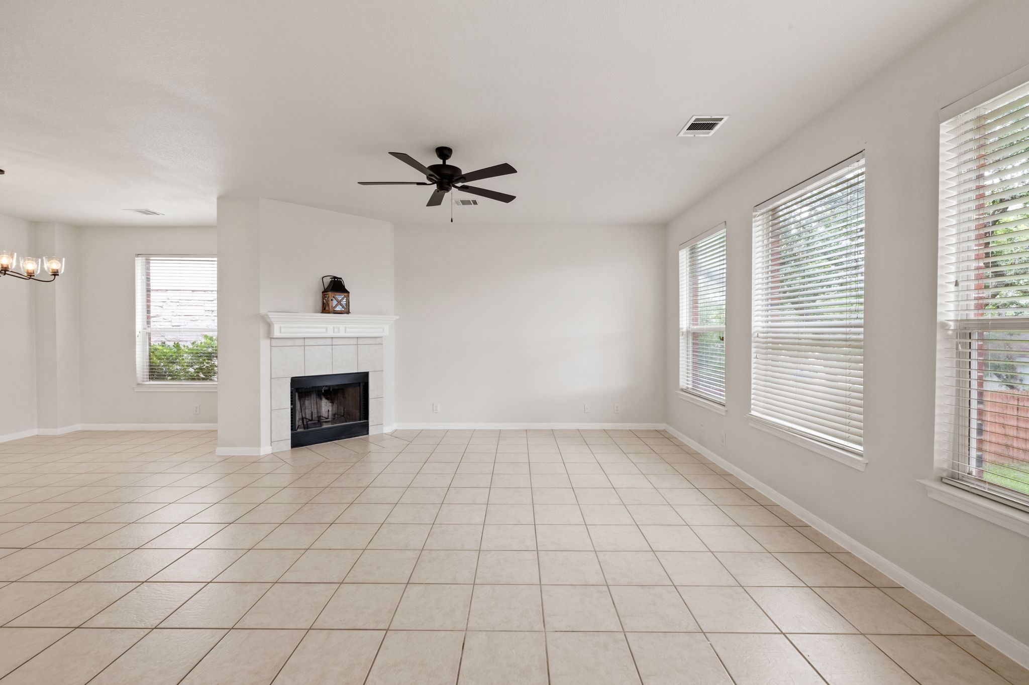 2732 Cascade Falls Drive Austin, TX 78738 - Photo 12 of 40 a view of an empty room with a fireplace and a window