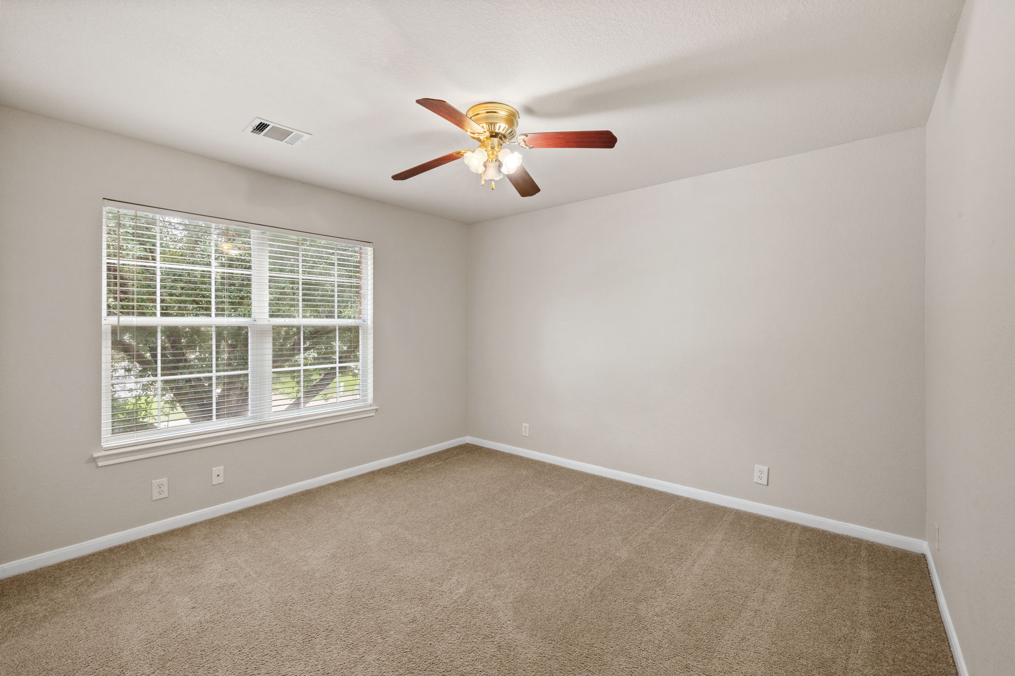 2732 Cascade Falls Drive Austin, TX 78738 - Photo 24 of 40 an empty room with windows and fan
