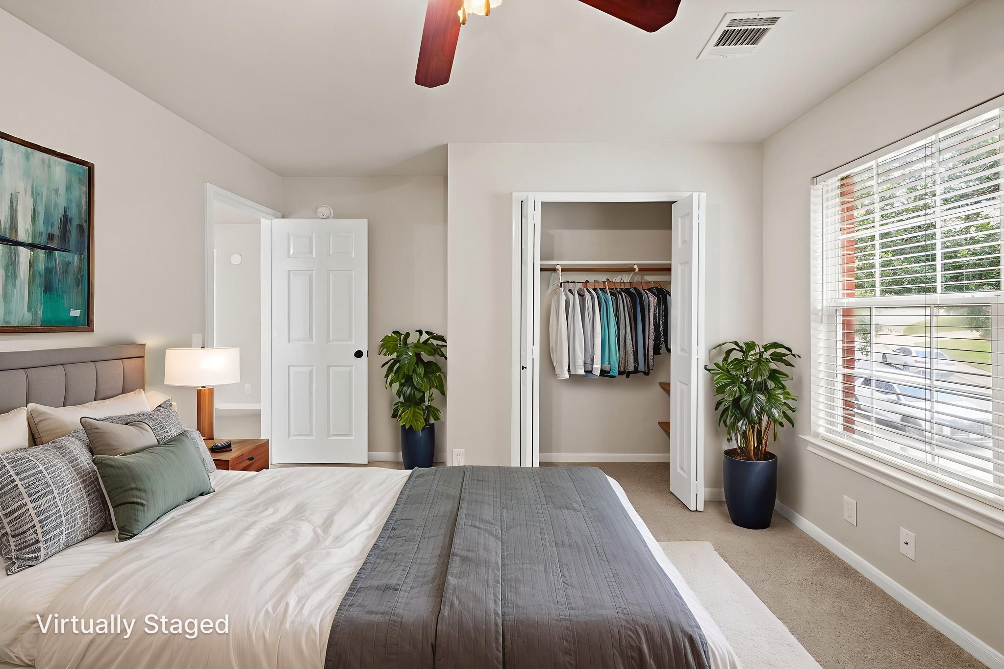 2732 Cascade Falls Drive Austin, TX 78738 - Photo 27 of 40 a bedroom with a bed a chandelier and a large window