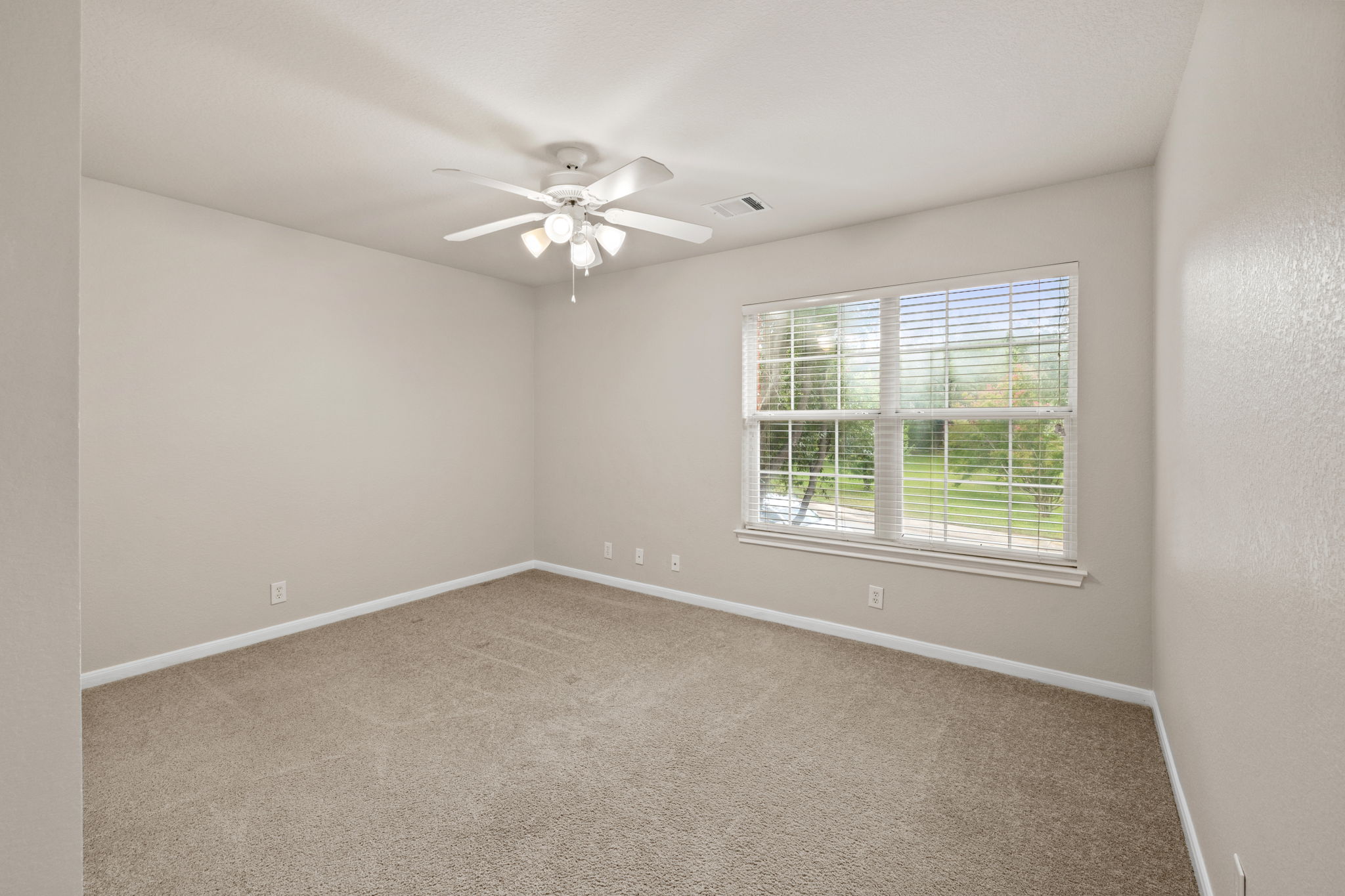 2732 Cascade Falls Drive Austin, TX 78738 - Photo 29 of 40 an empty room with a window and a fan