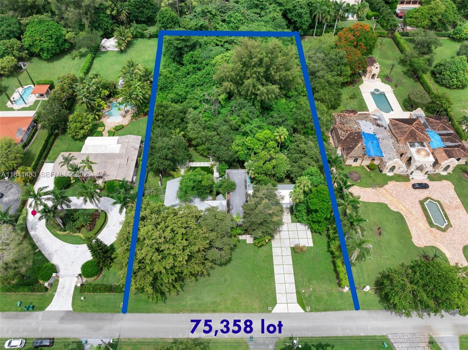 an aerial view of a house and trees all around