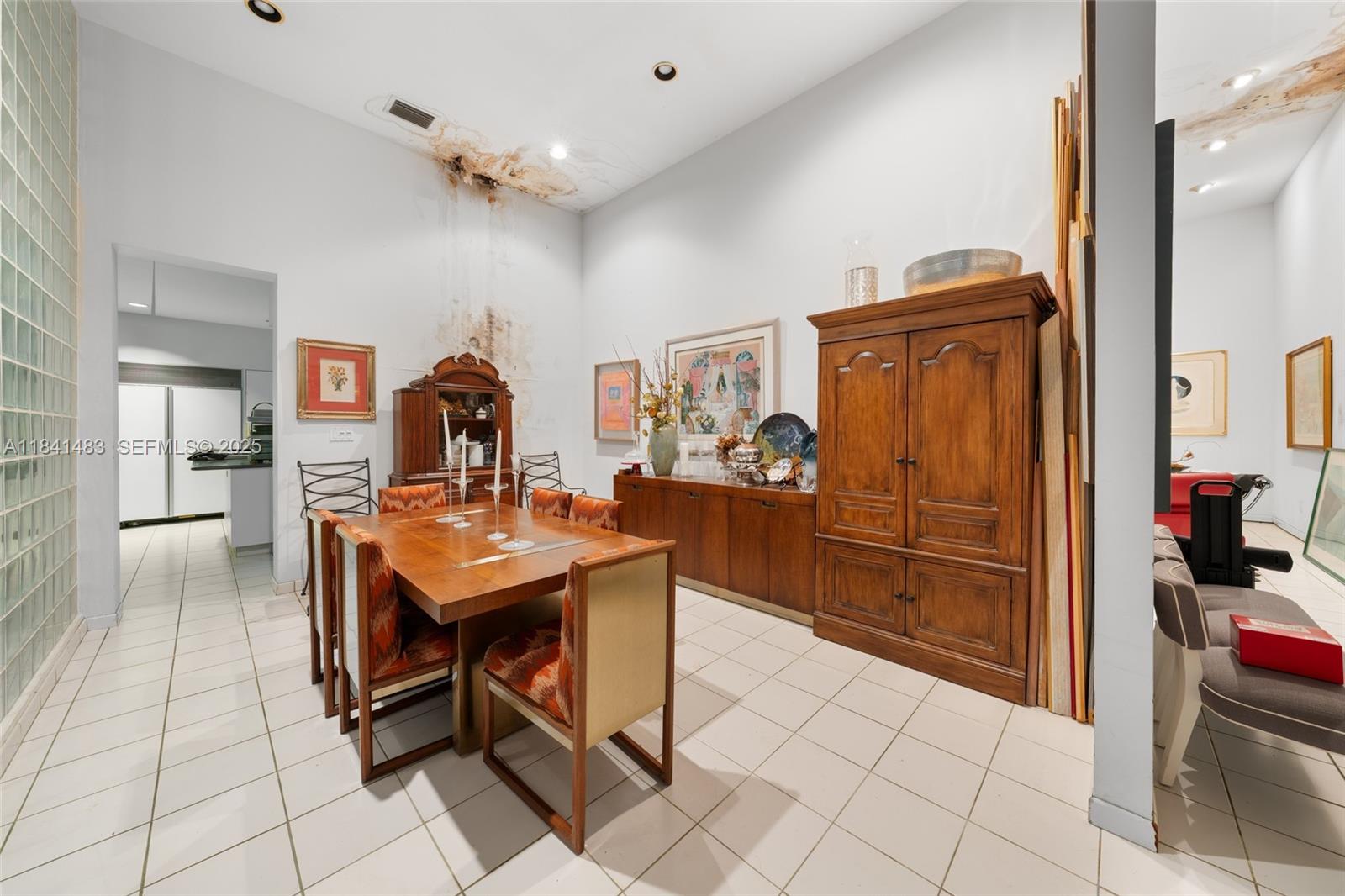 6002 Southwest 79th Court Miami, FL 33143 - Photo 14 of 47 a room with stainless steel appliances kitchen island granite countertop furniture and a refrigerator