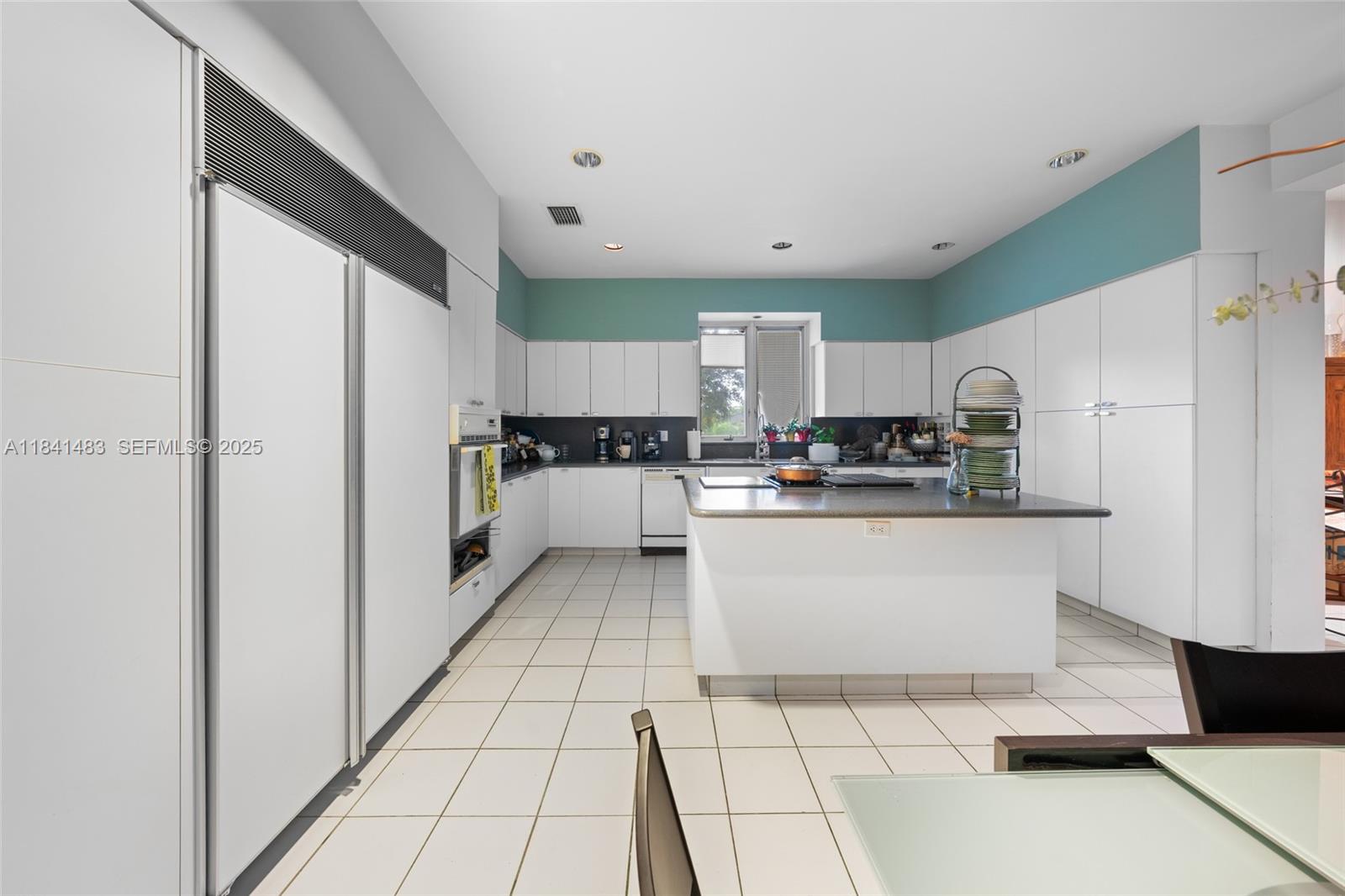6002 Southwest 79th Court Miami, FL 33143 - Photo 19 of 47 a kitchen with stainless steel appliances a refrigerator sink and microwave