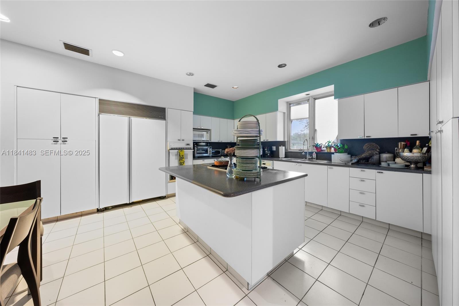 6002 Southwest 79th Court Miami, FL 33143 - Photo 20 of 47 a kitchen with a sink a stove and cabinets