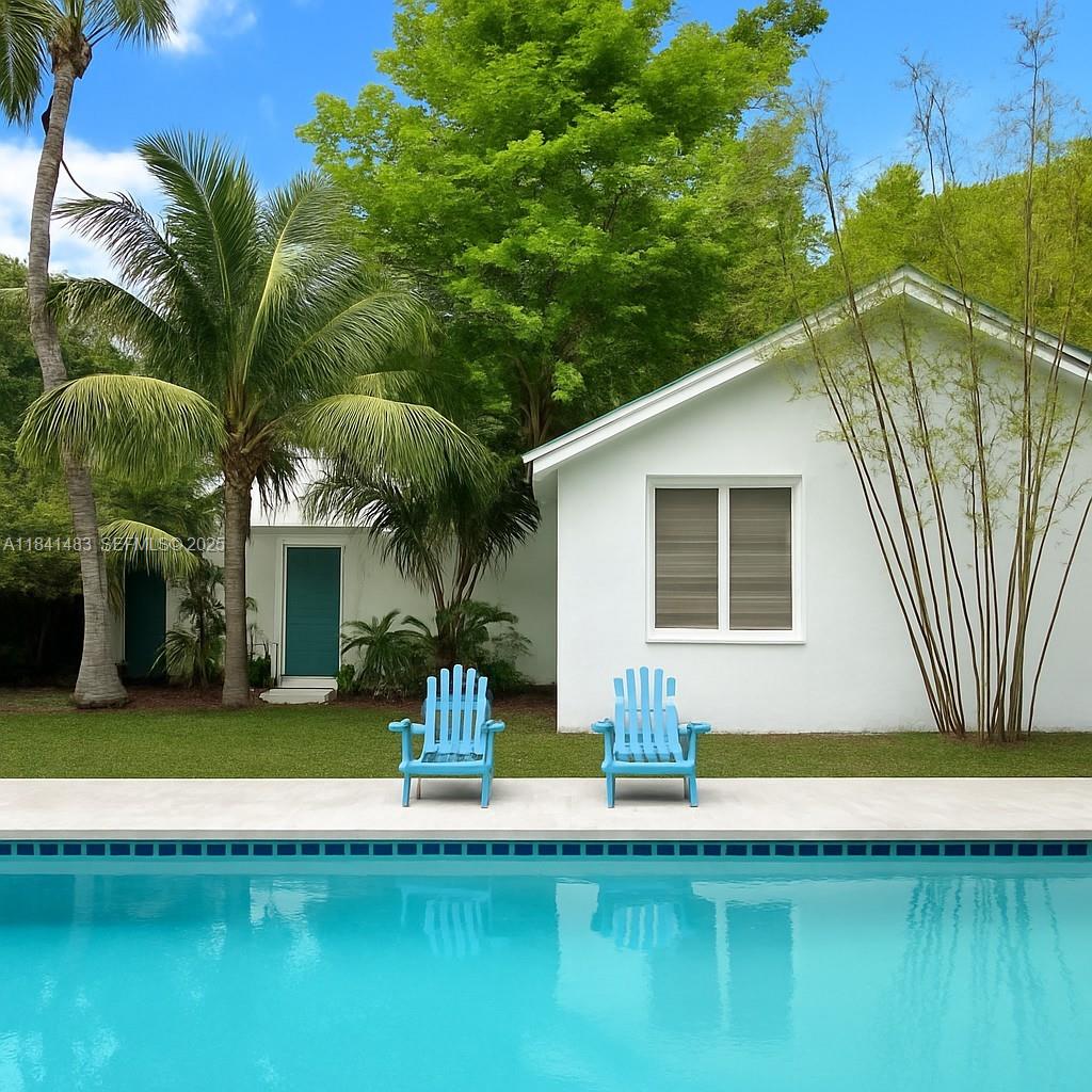 6002 Southwest 79th Court Miami, FL 33143 - Photo 36 of 47 a front view of a house with swimming pool having outdoor seating