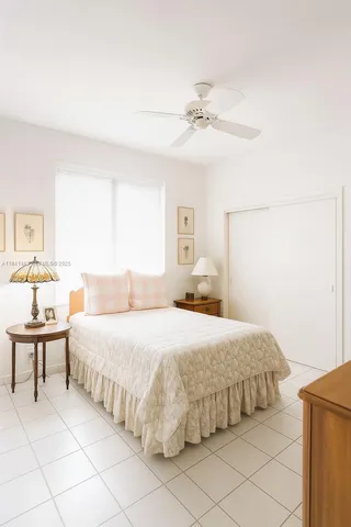 a bedroom with a bed and a lamp