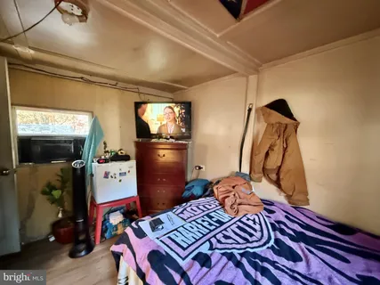 a bedroom with a bed and a dresser in it