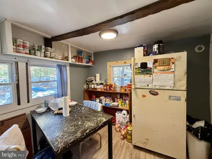 a view of kitchen island with furniture and wooden floor