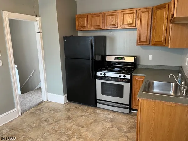 a kitchen with a stove and refrigerator