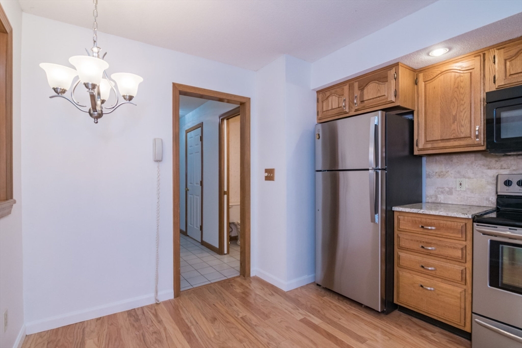 14 B Castle Hills Road, Unit 14B Agawam, MA 01001 - Photo 11 of 31 a kitchen with a refrigerator and a stove top oven