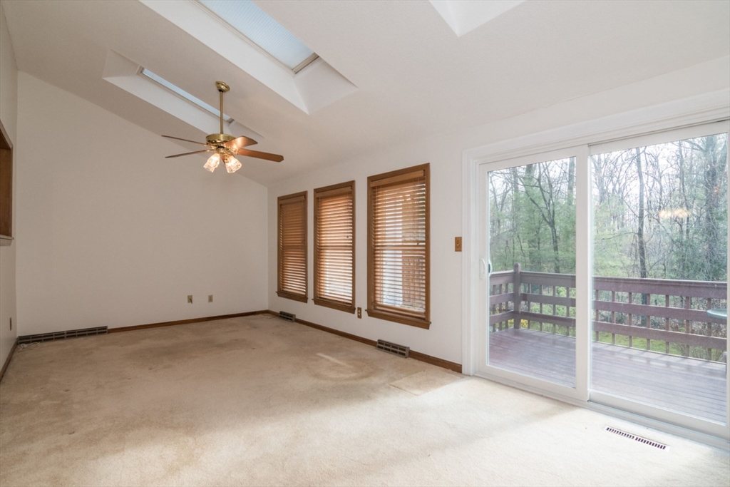 14 B Castle Hills Road, Unit 14B Agawam, MA 01001 - Photo 15 of 31 an empty room with windows and chandelier