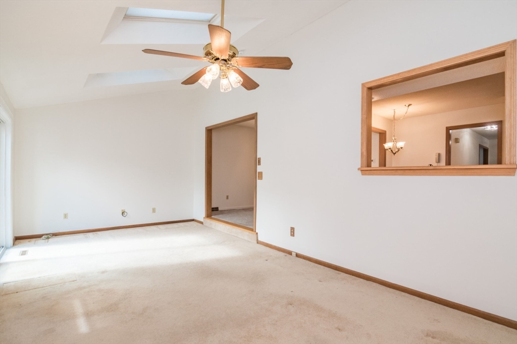 14 B Castle Hills Road, Unit 14B Agawam, MA 01001 - Photo 16 of 31 an empty room with a fan and a mirror