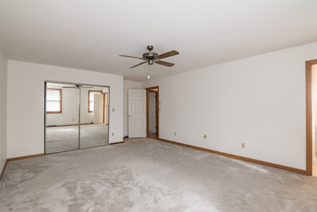 14 B Castle Hills Road, Unit 14B Agawam, MA 01001 - Photo 19 of 31 an empty room with chandelier fan and windows
