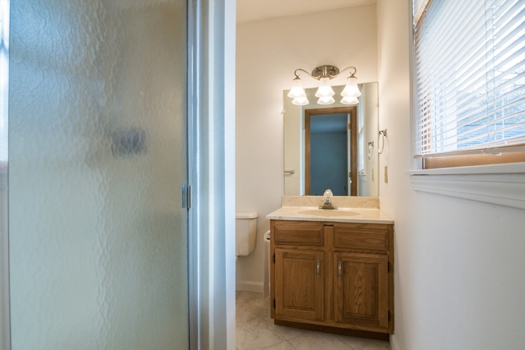 14 B Castle Hills Road, Unit 14B Agawam, MA 01001 - Photo 20 of 31 a bathroom with a granite countertop sink and a mirror