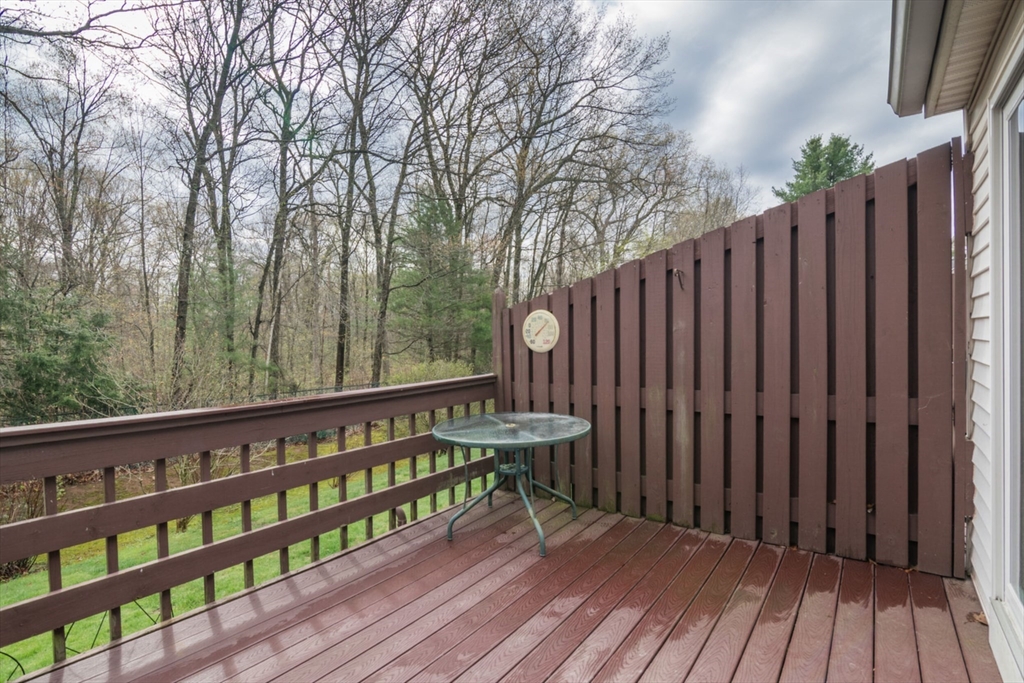 14 B Castle Hills Road, Unit 14B Agawam, MA 01001 - Photo 25 of 31 a wooden deck with trees in front of it