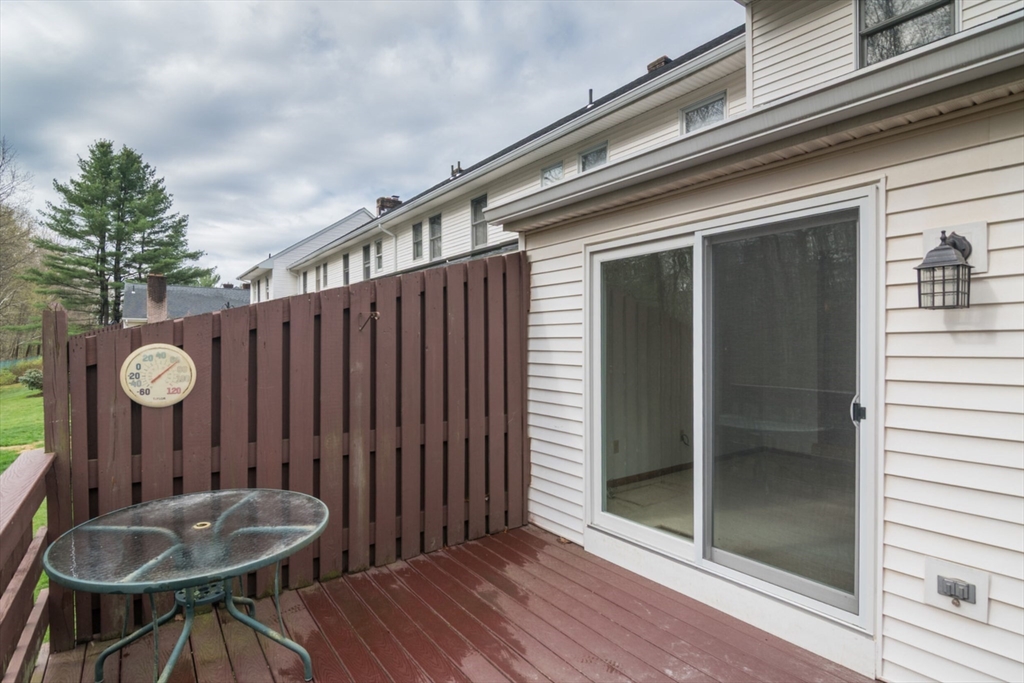 14 B Castle Hills Road, Unit 14B Agawam, MA 01001 - Photo 26 of 31 a backyard of a house with table and chairs