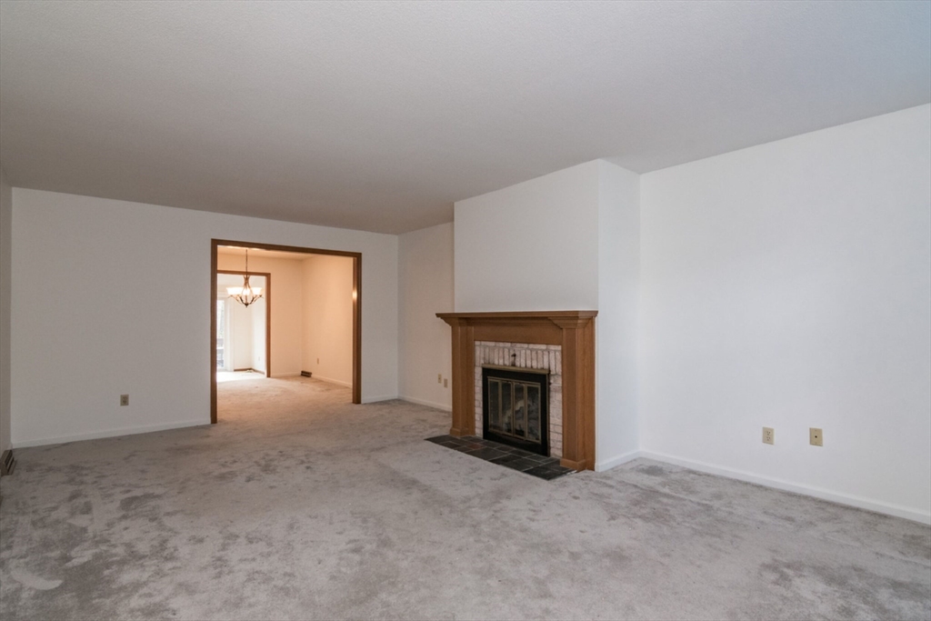14 B Castle Hills Road, Unit 14B Agawam, MA 01001 - Photo 6 of 31 a view of empty room with window and fireplace