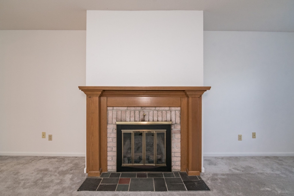 14 B Castle Hills Road, Unit 14B Agawam, MA 01001 - Photo 8 of 31 a living room with a fireplace