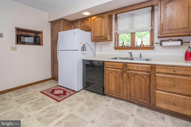 a kitchen with cabinets and white appliances