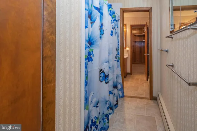 a bedroom with a bed and curtain