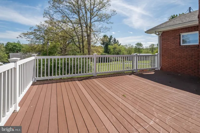 a balcony with wooden floor and fence