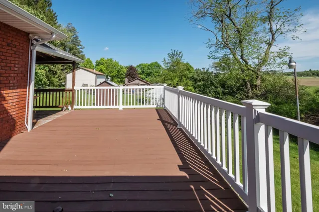 a view of balcony with wooden floor and fence