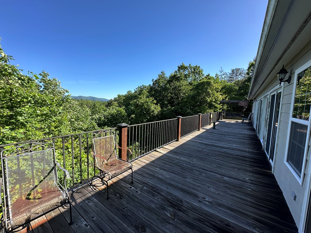 1207 Bullen Gap Road Blue Ridge, GA 30513 - Photo 23 of 37 a balcony with wooden floor next to a yard