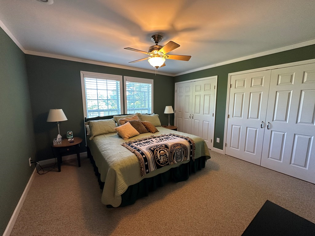1207 Bullen Gap Road Blue Ridge, GA 30513 - Photo 27 of 37 a spacious bedroom with a bed and a chandelier