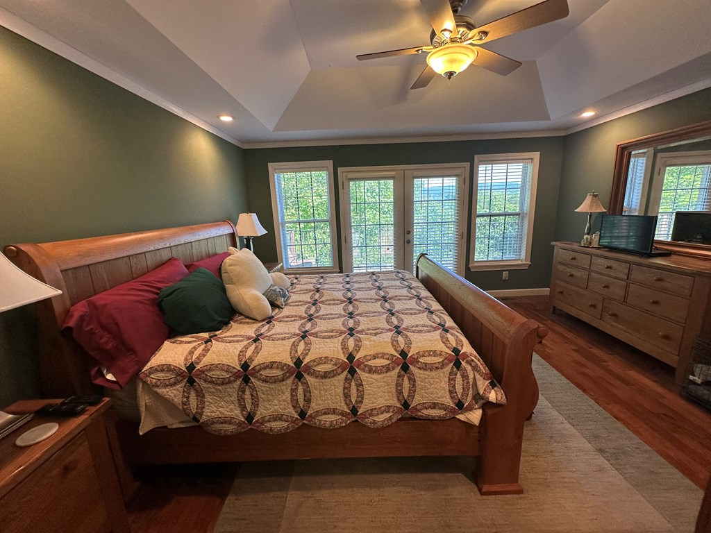 1207 Bullen Gap Road Blue Ridge, GA 30513 - Photo 6 of 37 a bedroom with a bed and a chandelier