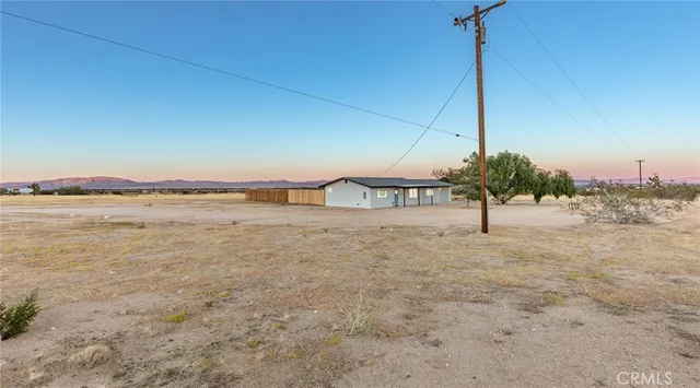 a view of an ocean & house in the background