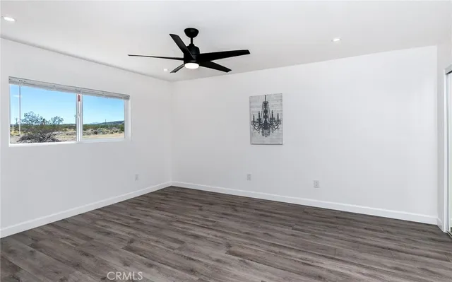 a view of a big room with wooden floor closet and windows