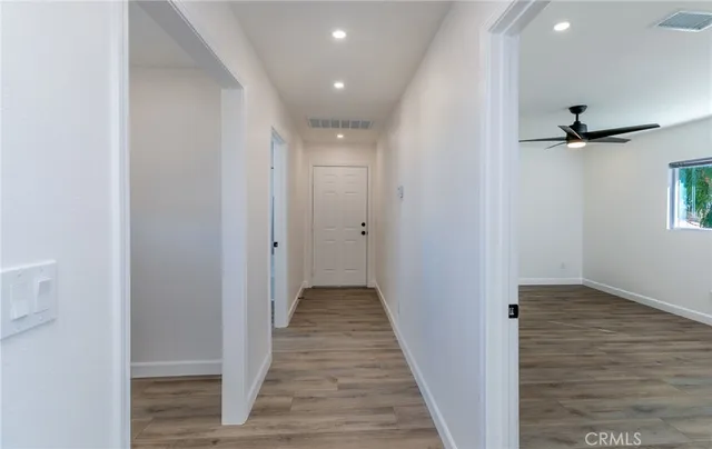 a view of hallway with wooden floor