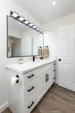 a bathroom with a double vanity sink and mirror