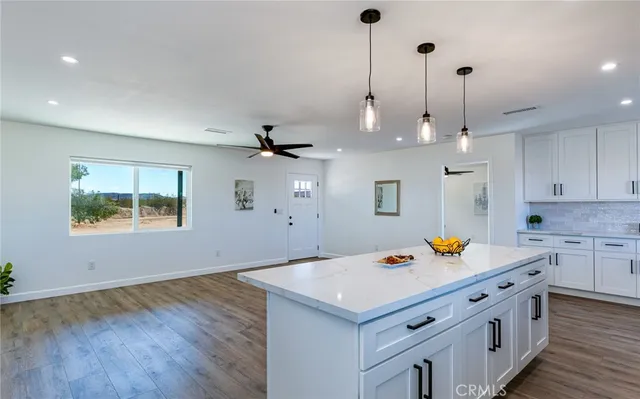 a kitchen with a sink a stove and cabinets