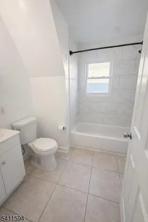 a bathroom with a toilet a sink and a shower
