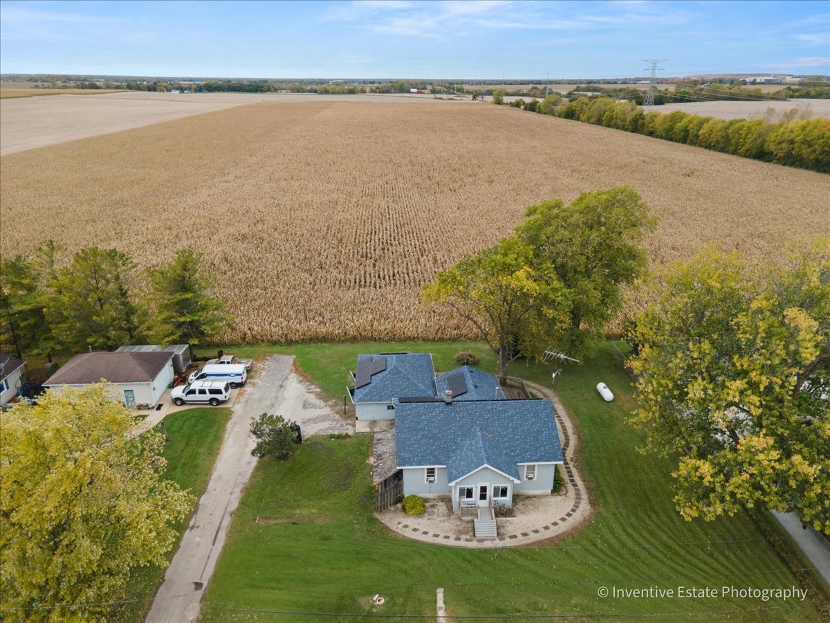 a aerial view of a house with a garden and lake view