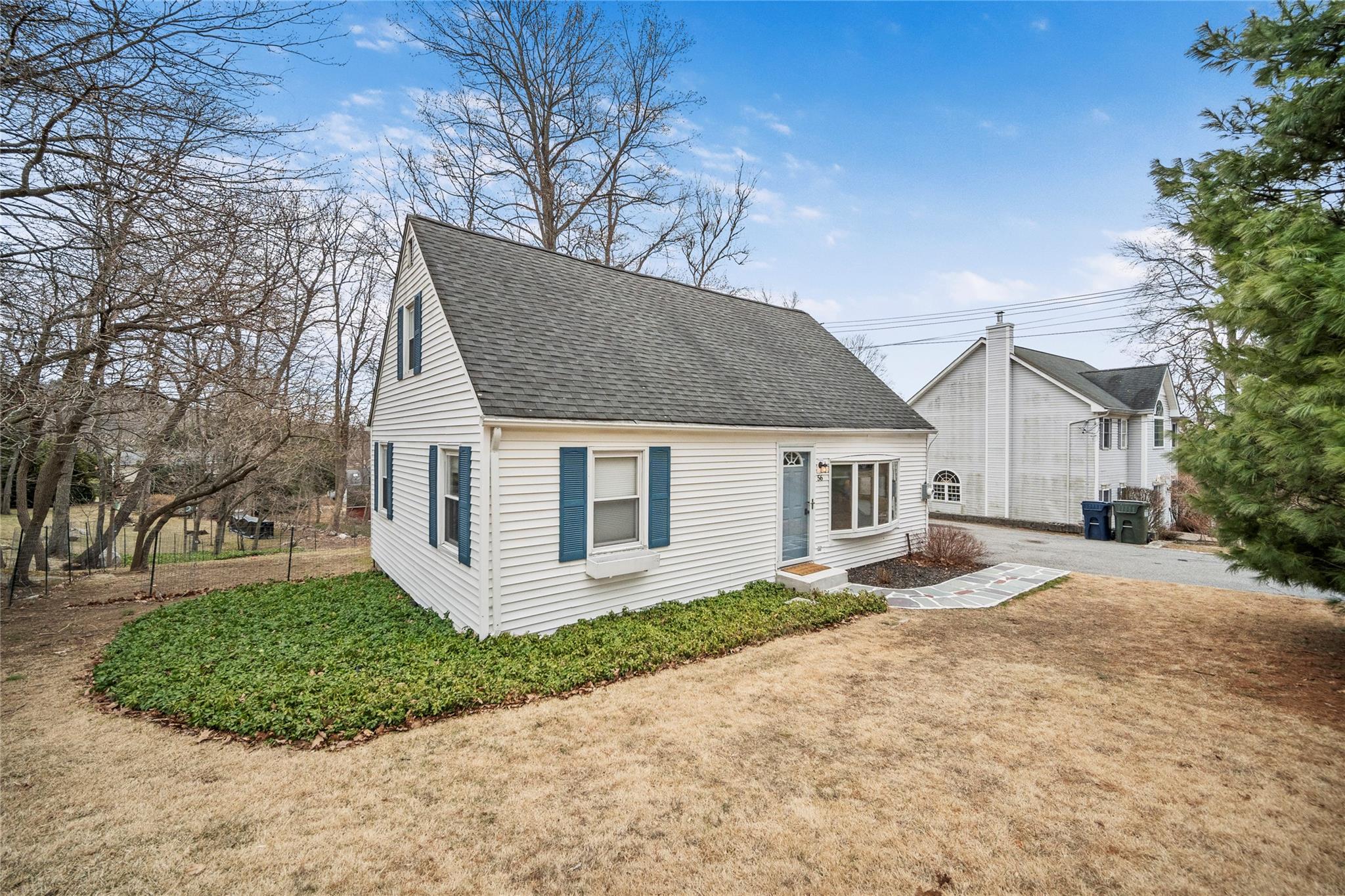 a house that has a tree in front of it