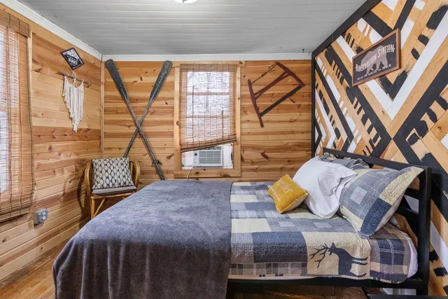 a bedroom with a bed and a window