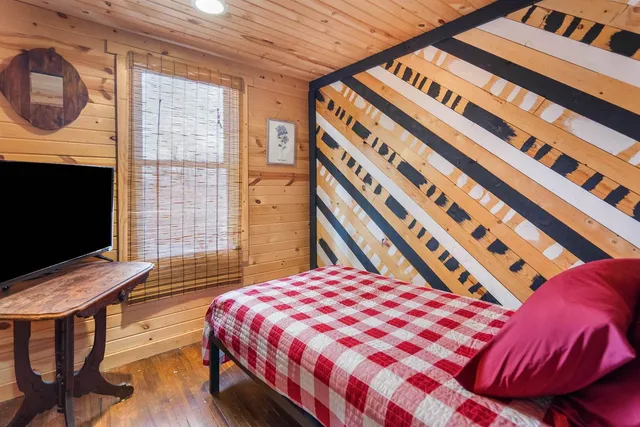 a bedroom with a bed and a television