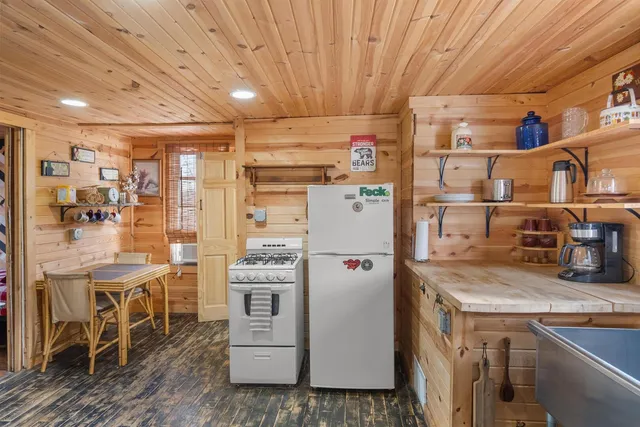 a kitchen with refrigerator and cabinets