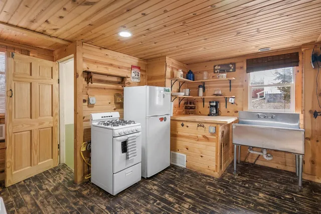 a kitchen with cabinets and wooden floor