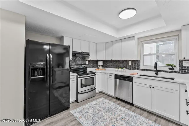 a kitchen with a sink stove and cabinets