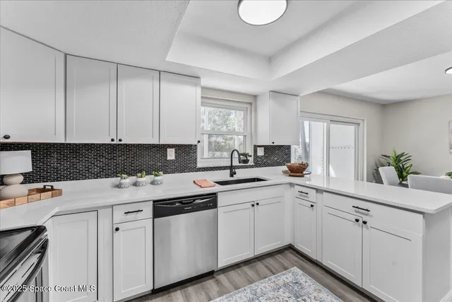 a kitchen with stainless steel appliances a sink and a granite counter tops