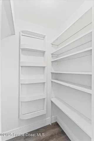 a spacious bedroom with a large bed and a large window