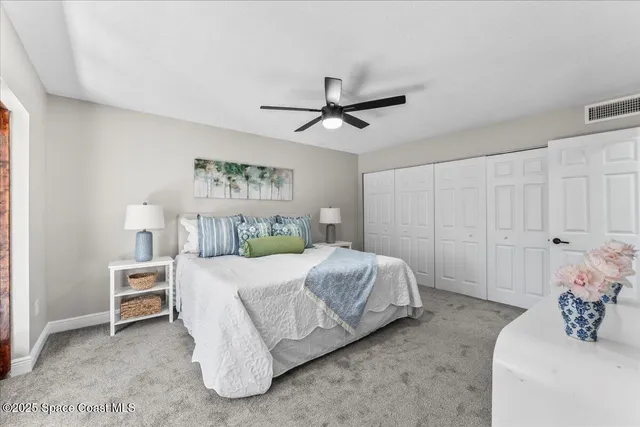 a bedroom with bed and a chandelier