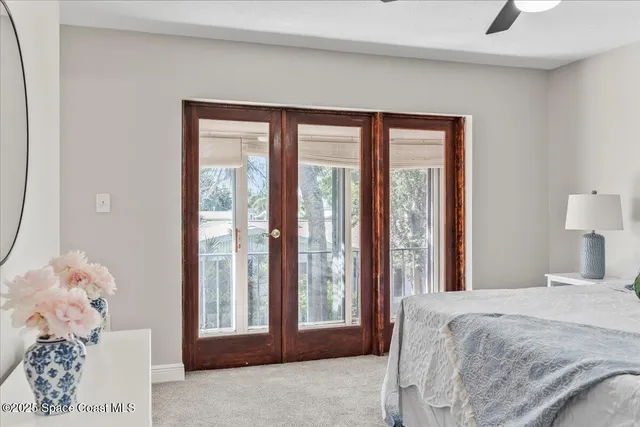 a bathroom with a sink a mirror and a potted plant