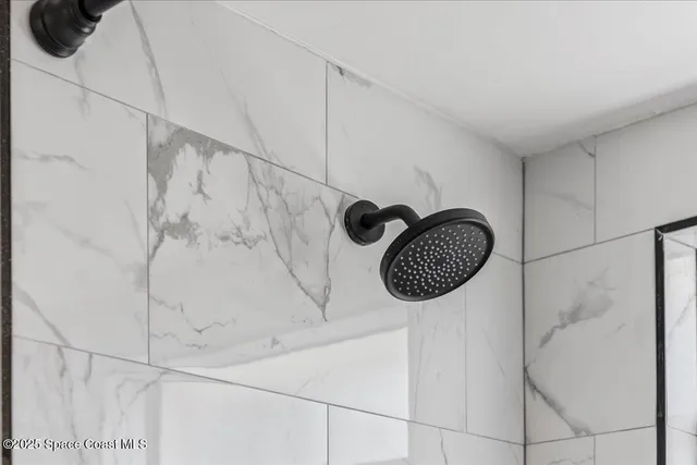 an empty room with wooden floor and ceiling fan