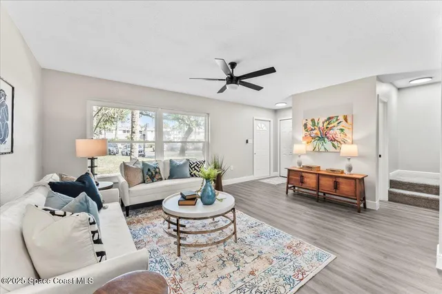 a living room with furniture rug and window