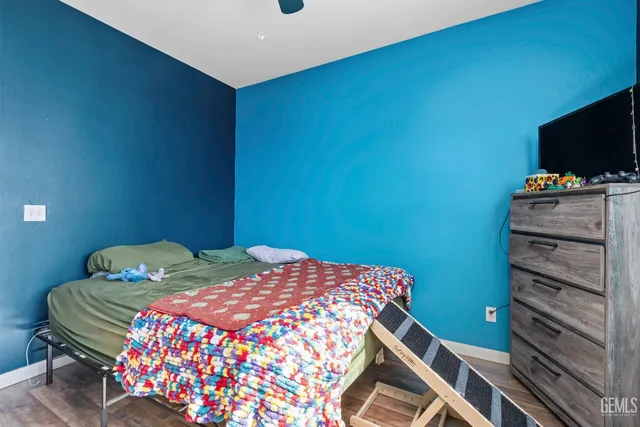 a bedroom with a bed and flat screen tv